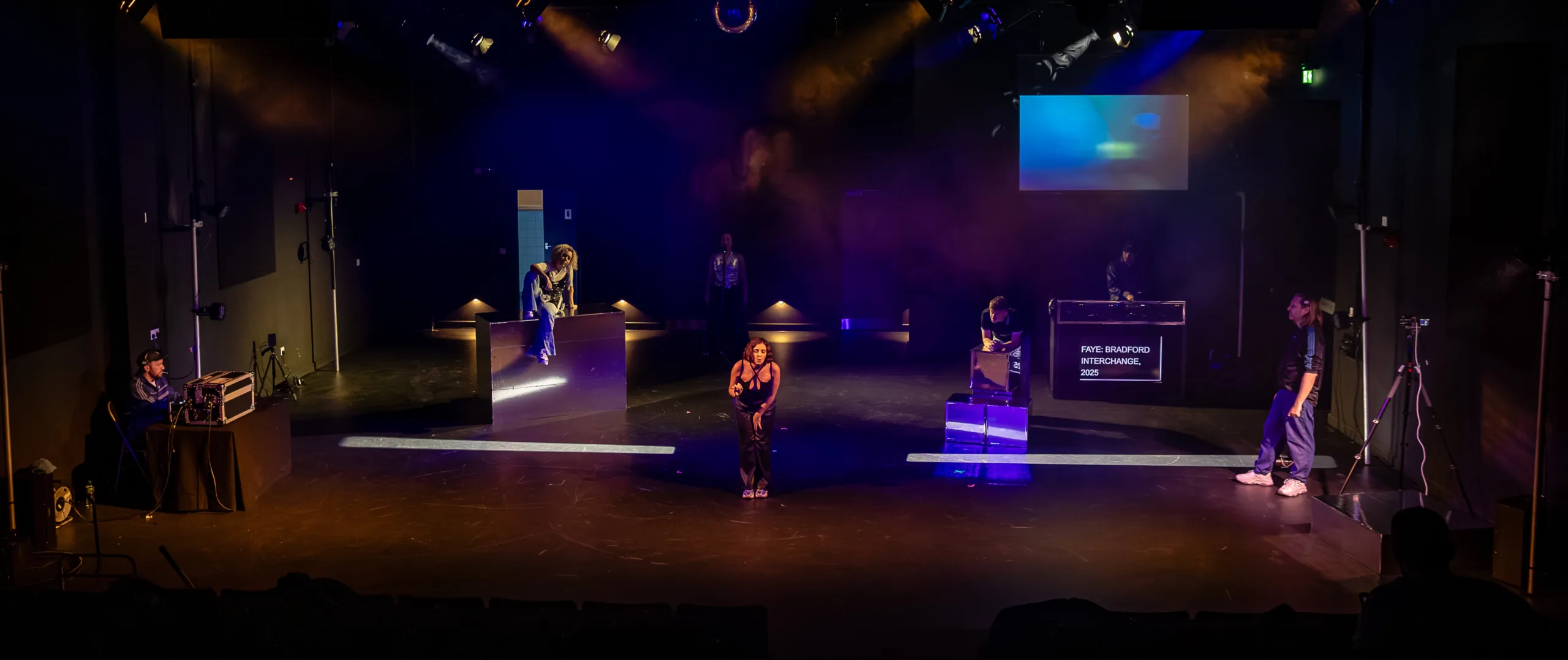 Theatrical performance with dramatic lighting.